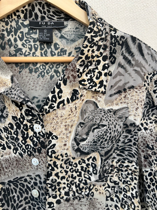 Leopard print shirt on a hanger with 'F.U.D.A' label.