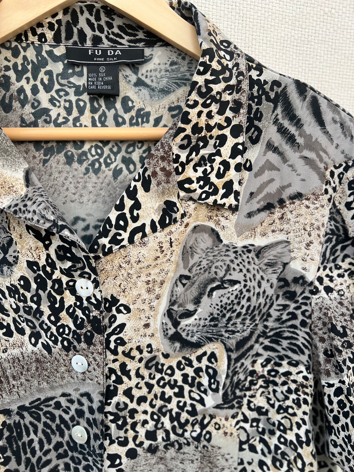 Leopard print shirt on a hanger with 'F.U.D.A' label.